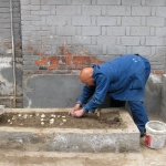  No space is wasted in the hutongs. Man planting garlic.
