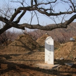 Lone headstone in shadow of the Great Wall.