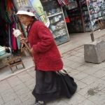 Tibetan woman spinning prayer wheel        