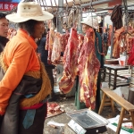 Tibetan monk choosing meat      