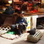 Woman cops a Nap while selling Chickens